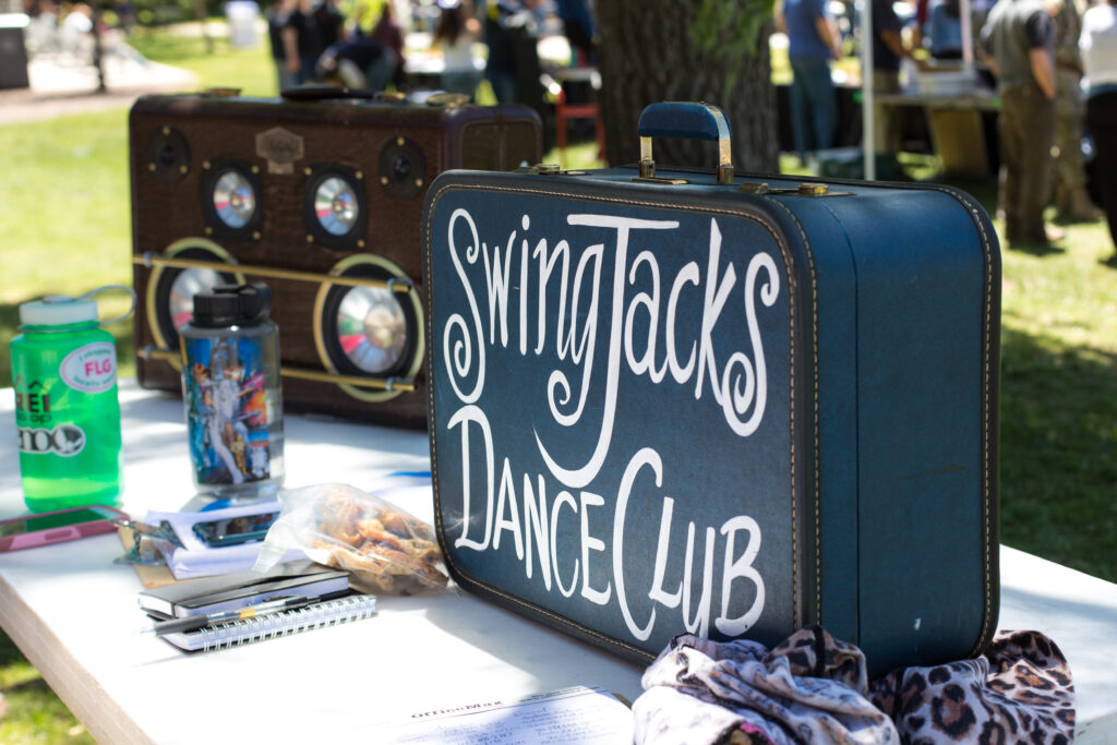 A navy blue trunk with Swing Jacks Dance Club written on it at the club fair