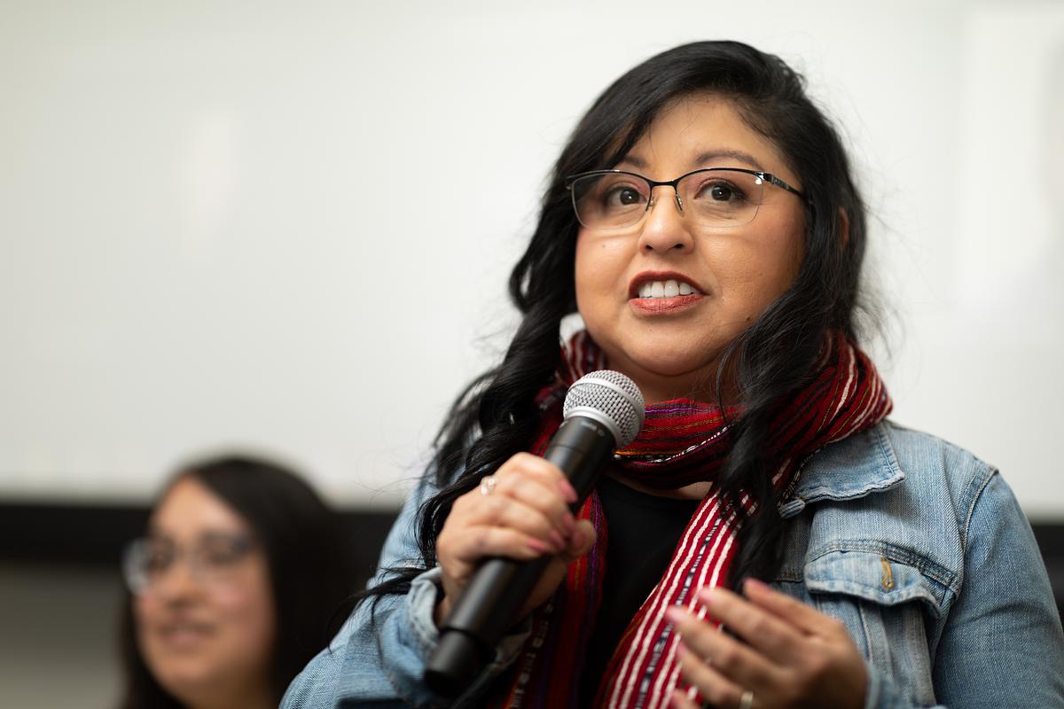 Claudia Rodas speaks into a microphone.